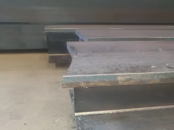 Bandsaw blade cutting crooked through large structural steel beam