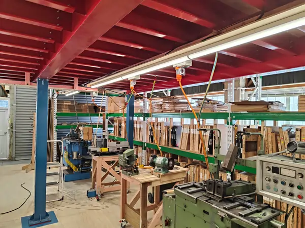 Industrial bandsaw blade production and welding workshop at United Products NZ showing coil inventory, grinding stations and blade welding equipment
